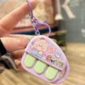 Cute music piano recorder keychain detail shot, showing the adorable cartoon bear pendant. - Pink Heart Cat