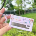 Close-up view of the mini electronic piano keychain toy featuring cute dog graphic and buttons. - Purple Dog