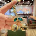 Gold cherry keychain with green crystal leaves, elegant metal bag pendant for women gifts. - Gold Metallic Green Leaf Cherry