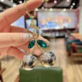 Cute cherry keychain bag charm with green crystal leaves and silver metallic finish pendant. - Silver Metallic Green Leaf Cherry