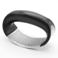 Stainless steel rocking garlic press with ergonomic black handle for kitchen cooking. - Grooved Garlic Press (Boxed)