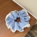 Detailed view of blue and white gingham hair scrunchie with delicate white lace trim. - B Style-Lace Blue Grid