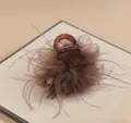 Close-up detail of the elegant brown feather hair claw clip, showing fluffy texture. - Ostrich Feather Hair Claw / Coffee