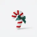 Detailed view of plush Christmas candy cane ornament with red stripes and green satin bow. - Candy Red White Candy Cane Small