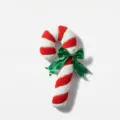 Close-up detail of the red and white striped plush candy cane pillow with a green bow. - L / ML-Q1114