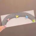 Close-up detail of the cute colorful heart hair comb for kids, flexible teeth design. - Heart Hair Side Comb
