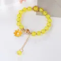 Yellow crackle crystal bracelet with cute daisy pendant detailed view close up style - Yellow