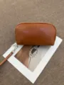 Brown leather cosmetic bag detail, semi-arched shape with wrist strap and smooth zipper. - 22*5.5*12CM / Brown