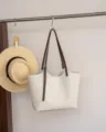 Detail view of the stylish cream leather tote bag with contrast brown straps and blue interior lining. - Top 40/Bottom 31*9*28CM / Rice Coffee