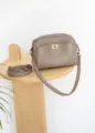 Taupe leather crossbody shoulder bag featuring a front turn-lock pocket and zipper compartment. - Length 22 Width 18 Height 9.5 / Trench Gray