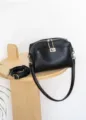 Close-up detail shot of black genuine leather shoulder bag featuring metal lock and zipper. - Length 22 Width 18 Height 9.5 / Black
