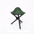 Portable folding tripod stool detail shot, showing green fabric and black metal tube frame. - Green