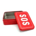 Detail view of the red metal emergency rescue SOS tin box, empty storage box interior. - SOS Box