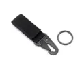Black tactical keychain carabiner with nylon webbing strap and metal snap hook for outdoor use. - Black