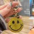 Alloy rhinestone smiley face keychain bag charm detail close up sparkling yellow crystal. - Yellow