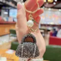 Sparkling rhinestone handbag keychain with gold hardware and pearl bead for keys and bags. - Gunmetal