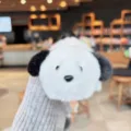 Close-up detail shot of the cute capybara plush keychain, showing soft white and black fur. - Capybara to Dog (Plush Animal Reversible)