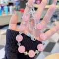 Pink crystal phone charm detail shot with sparkling beads and cute star pendant accessory. - Pink Beaded