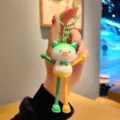 Close-up detail of cute gradient stretch pig keychain bag charm pendant, vibrant colors. - Gradient Extensible Pig - Green Orange