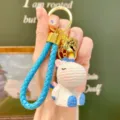 Cute resin unicorn keychain bag charm with blue braided strap and golden bell pendant. - Blue