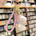 Resin unicorn keychain charm detail showing the cute braided strap and gold hardware. - Pink