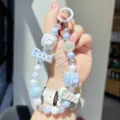 Cute macaron beaded phone chain with cute camera charms and letter beads, perfect phone accessory. - Purple