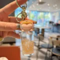 Portachiavi carino tazza di tè al latte riempito d'olio ciondolo bottiglia di sabbia borsa. - Ragazza arancione