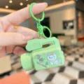 Close-up detail of the cute green camera projector keychain with lovely cat design. - Green Kitten