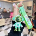 Green astronaut dog keychain, cute silicone bag charm and car key ring detail view. - Green Color Block Dog