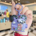 Close-up detail of the cute purple projector keychain featuring a lovely bear and film reel. - Purple Bear