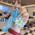 Cute liquid quicksand flower keychain with Sakura strap, clear charm bag pendant accessory. - Blue