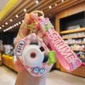 Cute grid camera projection light keychain, mini bag pendant and trendy aesthetic accessory for kids. - Pink