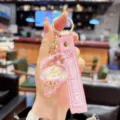 Detail shot of a cute pink liquid quicksand conch keychain with glitter and strap. - Quicksand Conch - Pink