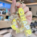 Detailed view of the cute acrylic quicksand candy doll keychain, lovely bag charm accessory. - Yellow
