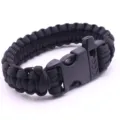 Black paracord survival bracelet with whistle buckle, durable seven-core weave detail. - Black