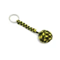 Close-up detail of black and yellow paracord monkey fist keychain, durable nylon material. - Black+Yellow