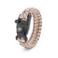 Detailed view of the survival paracord bracelet buckle featuring a built-in compass and whistle. - Desert Camouflage