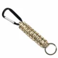 Desert color paracord keychain with black carabiner and metal ring for outdoor use. - Desert