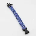Close-up detail view of the blue and black woven paracord survival bracelet with plastic buckle. - No. 111