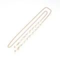 Detailed view of the gold-toned metal chain featuring clear faceted heart beads and loops. - Size 8 / White