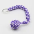 Vue détaillée du porte-clés poing de singe en paracorde violette et blanche avec anneau. - Violet Blanc