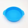 Round silicone cake mold in vibrant blue, non-stick baking pan with convenient side handles. - Blue Cake Mold