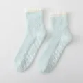 Light blue fluffy winter coral fleece socks with white anti-slip grip dots for home wear. - One Size / Light Green