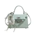 Light green polka dot Kelly crossbody bag for women with cute heart pendant and top handle. - With Pendant / Green