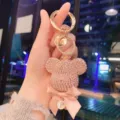 Detailed view of the sparkling rhinestone bear keychain with pink bow and letter pendant. - Pink