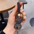 Close-up detail of the black rhinestone rabbit keychain, showing sparkling crystal texture. - Gunmetal