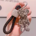 Portachiavi orsetto in strass brillante con cinturino in pelle intrecciata nera borsa charm - Nero misto