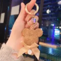 Rhinestone teddy bear keychain with bow and letter pendant, stylish metal ring bag charm. - Gold
