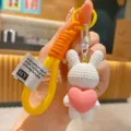 Cute resin rabbit keychain with pink heart pendant and woven strap for bags or car keys. - White