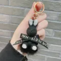 Detailed view of the cute black rhinestone rabbit keychain with sparkling crystal ears and bow. - Black